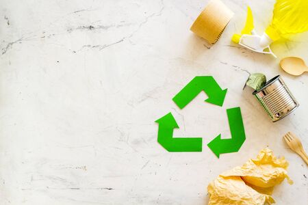 Green recycling symbol and different garbage for ecology on marble background top viewの写真素材