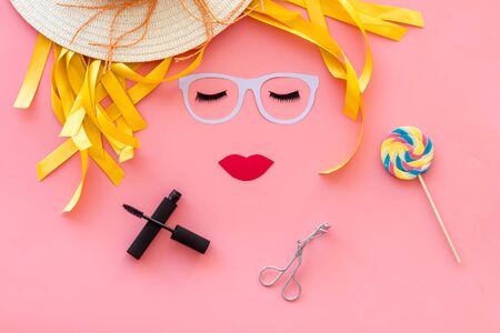 make up concept with face model for visagiste work and lollipop on pink background top viewの写真素材