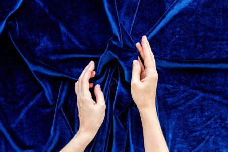 Blog design. Abstract blue fabric texture pattern with hands top viewの写真素材