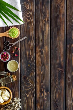 Cosmetics for hair care with jojoba, argan or coconut oil in bottle on wooden background top view mock-upの写真素材