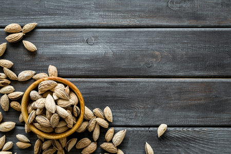 Healthy snack with almonds in bowls on wooden background top view mock up.の写真素材