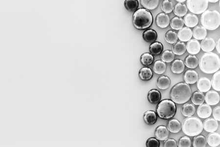 Monochromatic glass stones for decoration, creativity and home craft on gray background top view copyspaceの写真素材