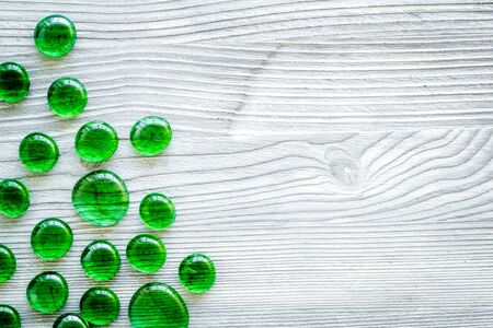 Pattern for blog. Glass stones for design and home creativity on white wooden background top view space for textの写真素材