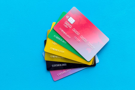 Business with credit cards on office desk blue background top view.