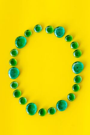 Pattern for design. Bright stones frame for design on yellow background top view mock upの写真素材