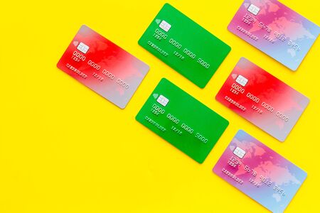 Business with credit cards on office desk yellow background top view mockup.の写真素材