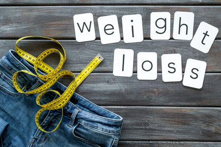 Diet, fitness and body shape. Trousers with measuring tape and weight loss concept for sport concept...