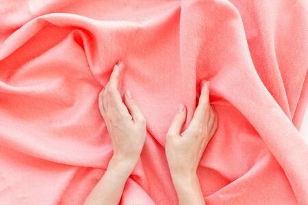 Abstract design. Pattern for blog with pink fabric texture and hands top viewの写真素材