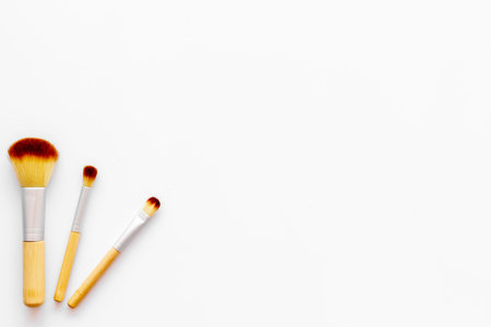 Visagiste work desk. Instruments for make up with brushes on white background top view mock upの写真素材