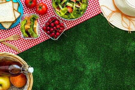 Picnic in summer with products, fruits, drinks and hat on white background top view space for textの写真素材