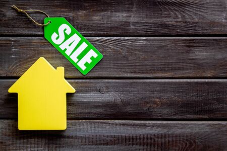 Black Friday discount. Sale for house with label and figure on wooden background top view copyspaceの写真素材