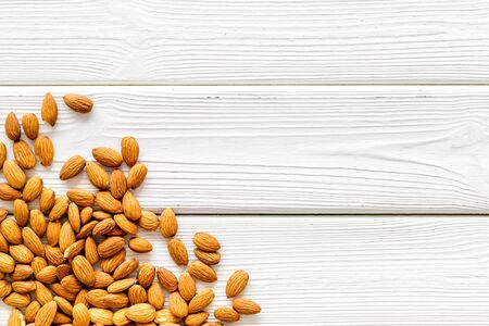 Nuts for snack. Almond on white wooden background top view space for textの写真素材