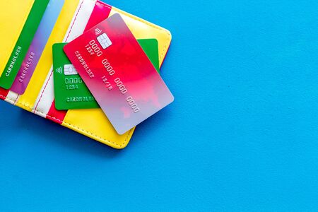 Business with credit cards and wallet on office desk blue background top view mock upの写真素材