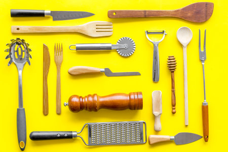Chef work space with cookware on yellow background top view pattern