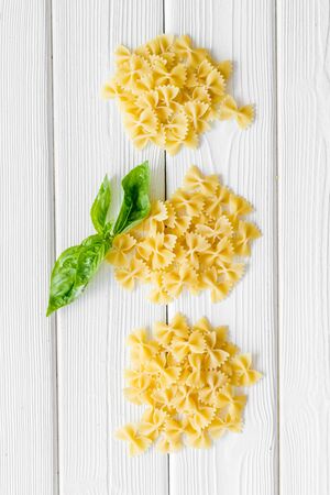 Italian cuisine. Uncooked paste on white wooden table background top viewの写真素材