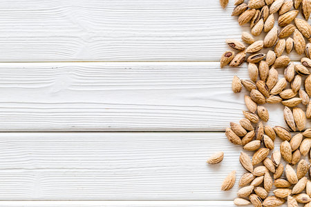 Nuts for snack. Almond on white wooden background top view space for textの写真素材
