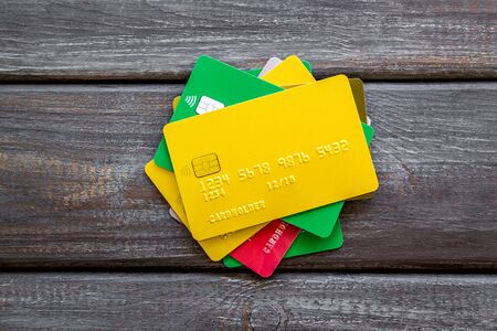Bank card, debit, credit for payment online on wooden background top viewの写真素材