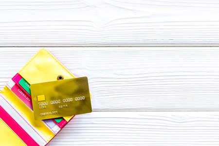 Bank card, debit, credit in wallet for payment online on white wooden background top view copyspace