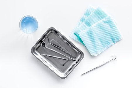 Teeth care and oral health. Dentist desk with instruments on white background top view