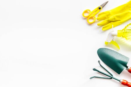 Rake, spade, scissors, gloves. Gardening tools on white background top view mock-upの写真素材