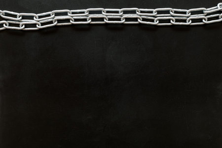Security from attack concept with chain on black background top view mock-up