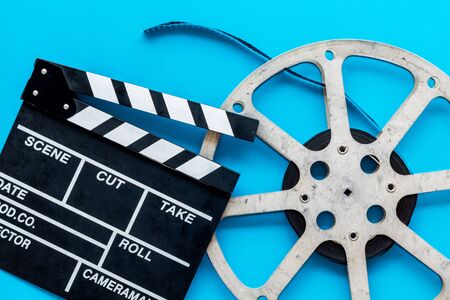 Go to the cinema with film type and clapperboard on blue background top viewの写真素材