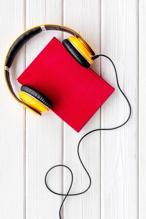 workplace with books and headphones on white wooden background flat layの写真素材
