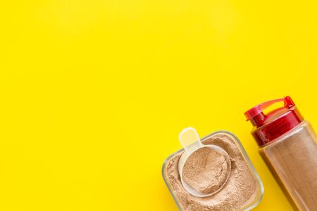 protein powder for fitness nutrition on yellow background top view mock-upの写真素材