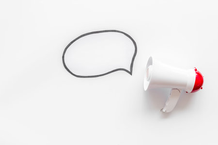 Megaphone with bubble for announcement text on white background top view space for text