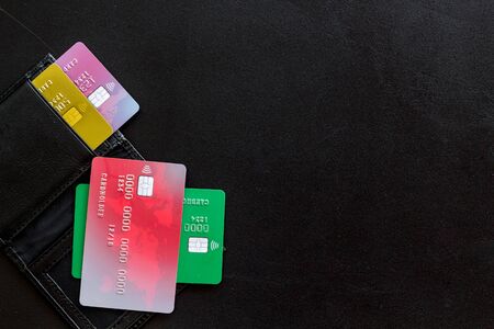 Pay by card concept and wallet on black background top view mock-upの写真素材
