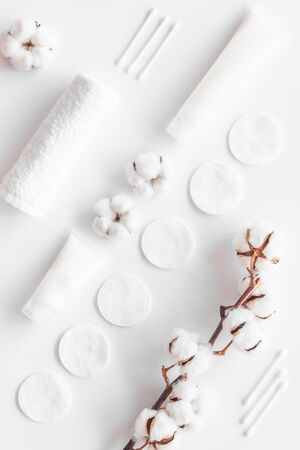 pattern of cosmetic cotton swabs, pads and cream on white background top view.の写真素材