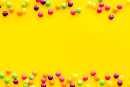 Sweets frame for pattern on yellow background top view copyspaceの写真素材