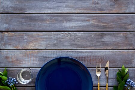 Table setting with plates, flatware and flower on wooden background top view copy spaceの写真素材