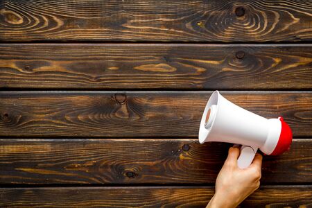 Attract attention with megaphone on wooden background top view copyspace