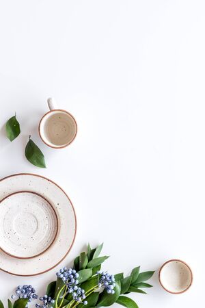 Table setting with plates and flower on white background top view copy spaceの写真素材