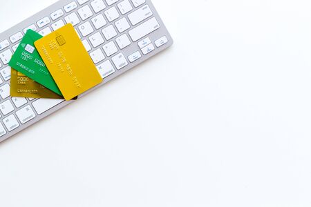 Bank card, debit, credit and keyboard for online purchase on white background top view copyspaceの写真素材