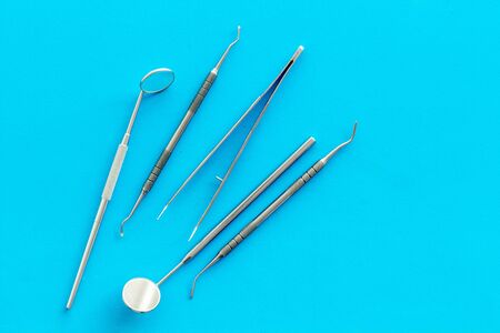 stomatologist instruments on blue doctors office desk background top viewの写真素材