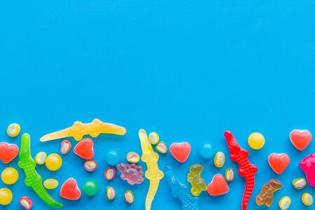 Candy dots and fruit jelly for blog design on blue background top view mock upの写真素材
