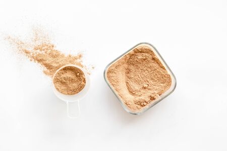 Sports nutrition with scoop and protein on white background top viewの写真素材