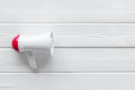 Announcement with megaphone on white wooden background top view mockup