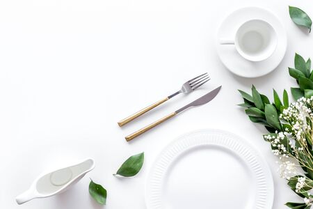 Elegant table setting with plates and tableware on white background top view mock upの写真素材