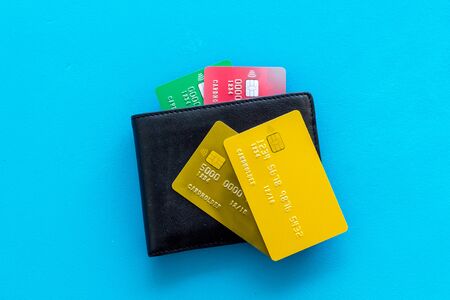 Pay by card concept and wallet on blue background top viewの写真素材