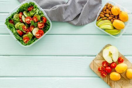 meal in lunch box to take away on mint green wooden background top view mockup
