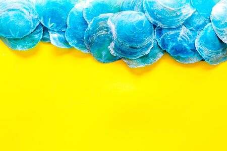 Shells pattern for design of blog on yellow background top view mock upの写真素材