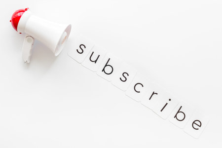 Announcement for subscribe with megaphone and text on white background top view.