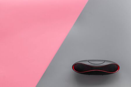 Portable wireless speakers as gadgets for listen to the music on pink and gray background top view copy spaceの写真素材