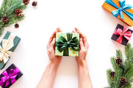 Frame from spruce and gift in hands for new year on white background top veiwの写真素材