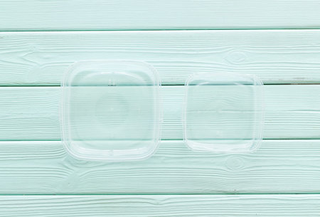 empty food container on mint green wooden background top view mockup