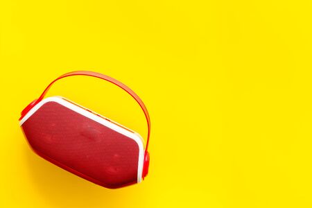 Portable wireless speakers as gadgets for listen to the music on yellow background top view space for textの写真素材