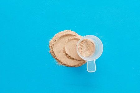 Sport diet with protein powder on blue background top viewの写真素材